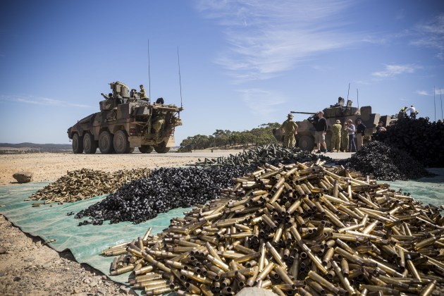 The Rheinmetall Boxer CRV (left) prepares for another run through the Puckapunyal Armoured Fighting Vehicle Field Firing Training Area, while Defence members talk to BAE Systems Australia representatives about the Patria AMV35 (right) during the Land 400 Risk Mitigation Activity on 22 February 2017. In August the Land 400 Phase 2 RMA concluded. Credit: Defence