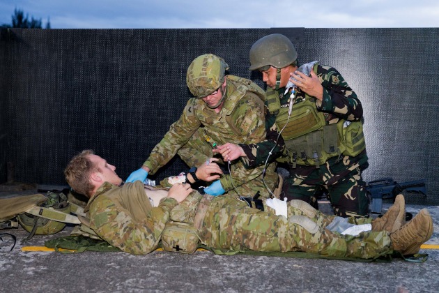 Caption: Australian Army soldier Corporal David Bell from Joint Task Group 629 and a Philippines Army soldier provide medical care to a casualty during an urban combat skills demonstration at the Armed Forces of the Philippines Headquarters in Manila, Philippines.
Credit: Defence