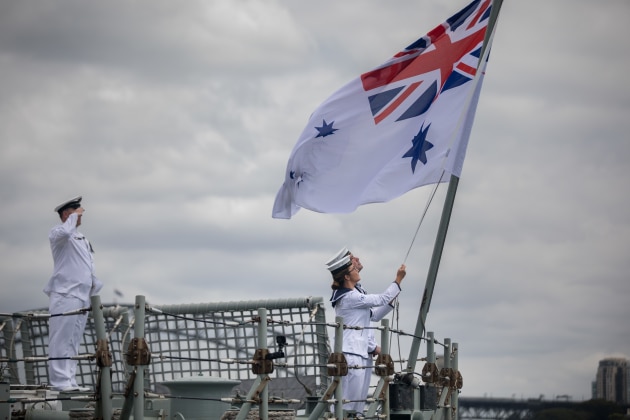 Able Seaman Communication and Information Systems Samuel Millar and Able Seaman Communication and Information Systems Alice Saunders lower HMAS Darwin&rsquo;s Australian White Ensign for the last time. Defence