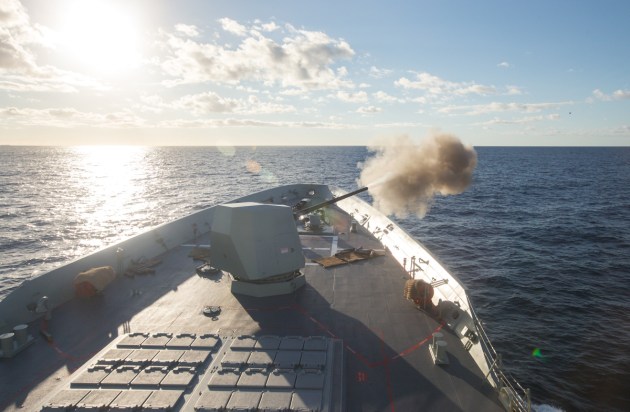 The Mark 45 Mod 6 5-inch gun of HMAS Hobart engages a towed surface target during weapon trials. Defence