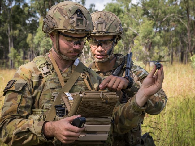 Australian Army soldiers Trooper Chris Perks (left) and Trooper Sam Menzies with a PD-100 Black Hornet Nano unmanned aircraft vehicle. Defence
