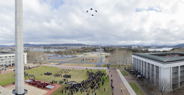 Four Royal Australian Air Force F/A-18 Hornets conduct a fly past during the change of command parade. Defence