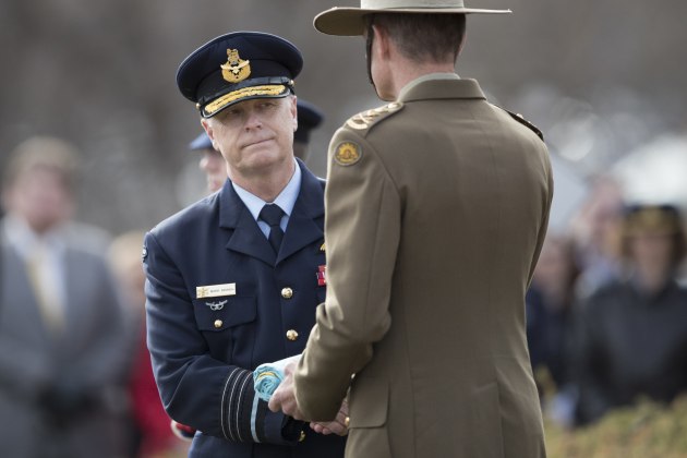 Outgoing Chief of Defence Force, Air Chief Marshal Mark Binskin, hands over the Chief of Defence Force flag to incoming Chief of Defence Force, General Angus Campbell. Defence
