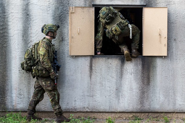 Soldiers of the 2nd Battalion, Royal Australian Regiment, clear an urban training complex as part of an amphibious assault. Defence