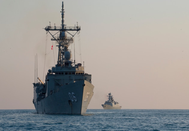 HMAS Newcastle (left), and Chinese ship, PLA-N Huangshan, at anchor north of Melville Island during Exercise Kakadu 2018. Credit: Defence