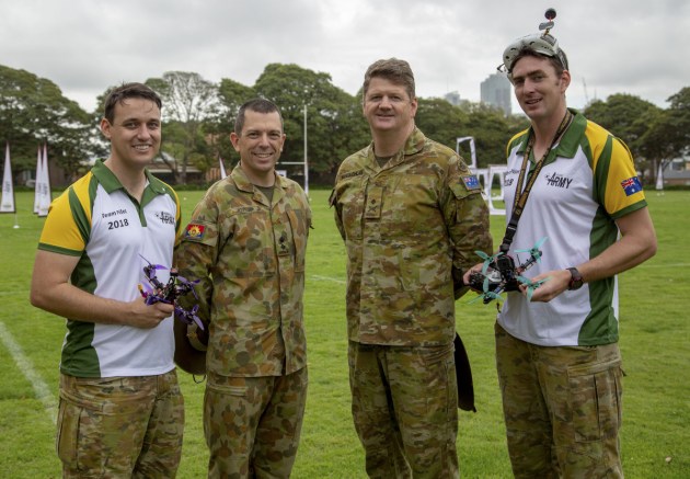 (l-r) Australian Army personnel, Captain James Jenkins, Lieutenant Colonel Keirin Joyce, Commander Forces Command, Major General Gus McLachlan, AO, and Lance Corporal Cameron Webster, at the International Drone Racing Tournament racing track at Victoria Barracks, Sydney. Defence