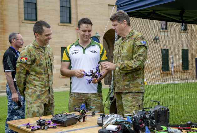 Captain James Jenkins (middle), takes Lieutenant Colonel Keirin Joyce (left), and Commander Forces Command Major General Gus McLachlan (right), through different components of a drone. Defence