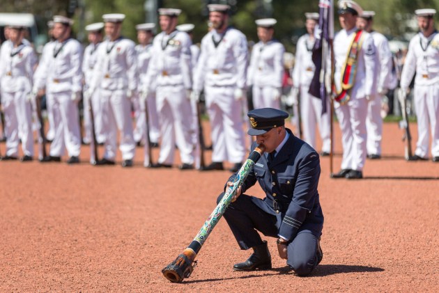 RAAF officer Wing Commander Jonathan Lilley plays the didgeridoo during the Remembrance Day Ceremony at the Australian War Memorial, Canberra. Defence