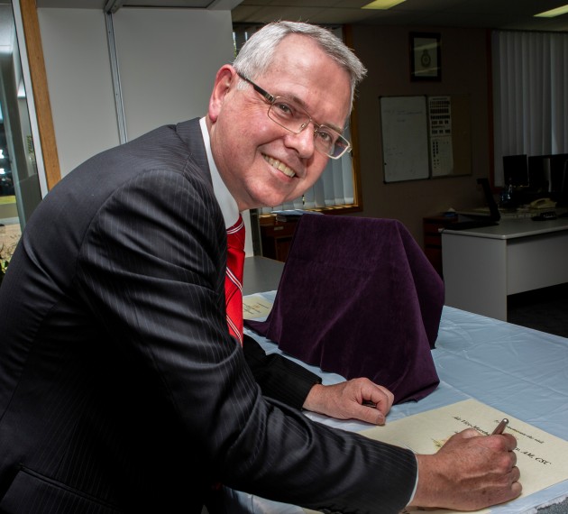 Air Vice Marshal Kym Osley signs the visitors book during the official ceremony renaming of No.1 Flying Training School to Air Mission Training School at RAAF East Sale. (Defence)