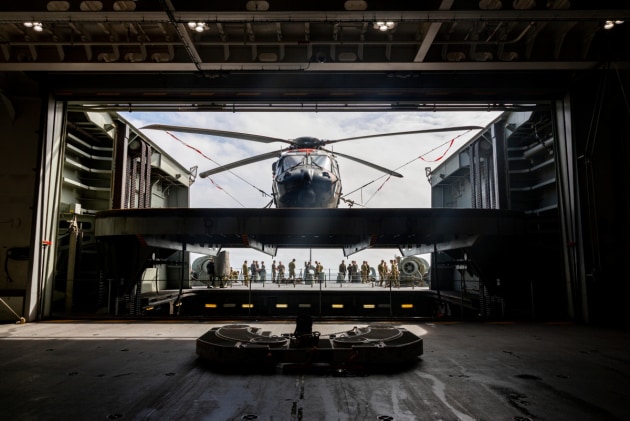 MRH-90 Multi-Role Helicopter being moved from the hangar to the flight deck onboard HMAS Canberra during Exercise Talisman Sabre. Credit: Defence
