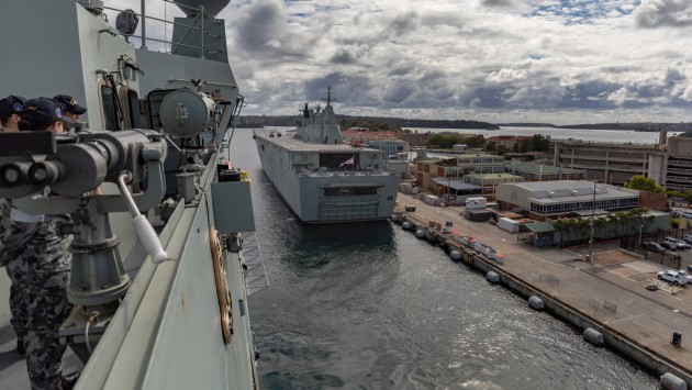 HMAS Adelaide manoeuvres past HMAS Canberra as the ship departs Fleet Base East, Sydney, en route to take part in Operation Render Safe. 

Credit: Defence