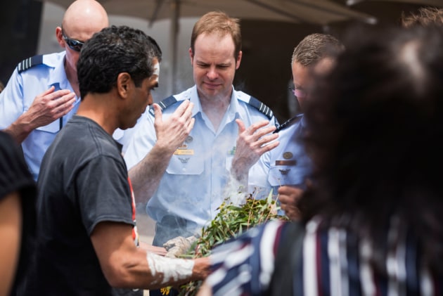 Royal Australian Air Force Wing Commander Daniel Drinan takes part in a smoking ceremony at the launch. (Defence)