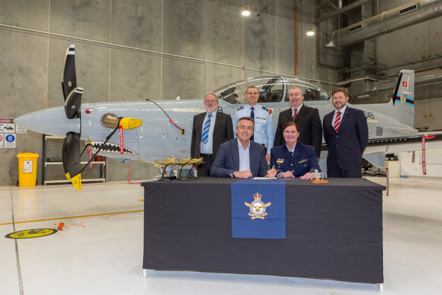 Minister for Veterans and Defence Personnel Darren Chester MP (r), and Air Force officer, Head of Air Force Capability, Air Vice-Marshal Catherine Roberts, sign the Certificate of Achievement at the final delivery ceremony for the new RAAF Pilatus PC-21s. (Defence)