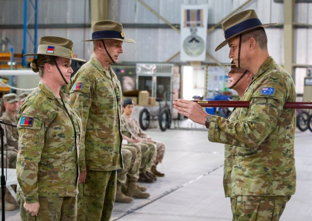 Incoming Commander of Joint Task Force 633 (JTF633) Major General Susan Coyle, CSC, DSM and outgoing Commander of JTF633 Rear Admiral Mark Hill, CSC, RAN complete the hand over of the pace stick to the incoming Command Warrant Officer, Warrant Officer Jason Randell. (Defence)