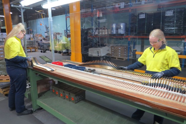 Thales Australia employees conduct the final visual inspection of .50 calibre ball linked ammunition on the production line at Benalla. (Defence)