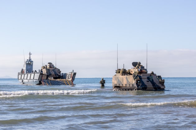 M113 Armoured Personnel Carriers are transported from HMAS Canberra via Landing Craft, prior to a beach assault. (Defence)