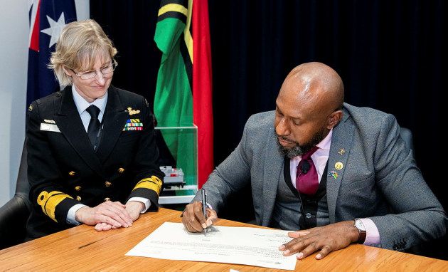 Royal Australian Navy officer Rear Admiral Katherine Richards, Head of Navy Engineering, watches as His Excellency Samson Vilvil Fare, High Commissioner for Vanuatu, accepts the twelfth Guardian-class patrol boat RVS Takuare on behalf of the Vanuatu Government via live stream from Canberra. (Defence)