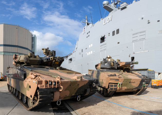 Hanwha Defense Australia&rsquo;s Redback (left) and the Rheinmetall Defence Australia&rsquo;s KF41 Lynx ready to board HMAS Adelaide. (Defence)