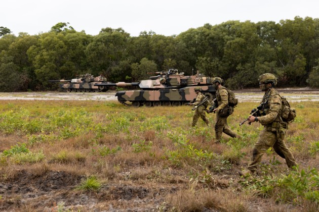 Soldiers from the 1st Battalion, The Royal Australian Regiment and the 2nd Cavalry Regiment, patrol through Cowley Beach Training Area. (Defence)