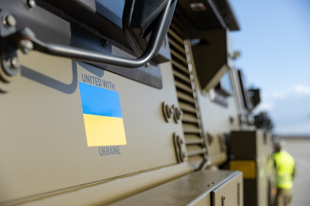 "United with Ukraine" and the Ukraine flag have been painted onto the sides of Australian Army Bushmaster Protected Mobility Vehicles being supplied to Ukraine. This example is seen during trans-shipment at a European airport. (Defence)