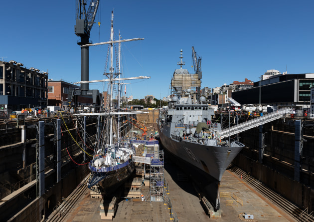 STS Young Endeavour and HMAS Arunta conduct maintenance within the Captain Cook Graving Dock on Garden Island, NSW. (Defence)