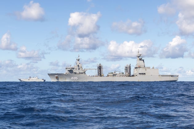 HMAS Supply (foreground) in company with HMAS Canberra during a boat transfer evolution, as part of the Regional Presence Deployment 2022. 

Credit: Defence