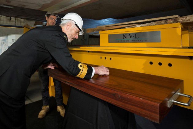 RADM Peter Quinn, Head Navy Capability, Royal Australian Navy, positions the keel laying coin at the OPV 5 keel laying ceremony, alongside Mr Bertrand Gorjux, Shipbuilder Luerssen Australia. (Image: Defence)