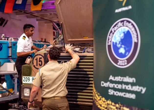 Australian Army personnel showcase a Bushmaster PMV to Indian Navy representatives during the Australian Defence Industries Showcase onboard HMAS Adelaide. (Defence)