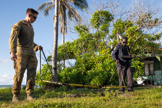 Australian Army Explosive Ordnance Disposal Technician Corporal Joel Macmillan and Royal Solomon Islands Police Force Constable Armstrong Ragoso survey the coastline using metal detection equipment during Operation Render Safe, Nauru.
Credit: Defence