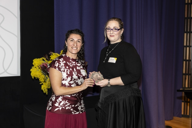 Rebecca Cook accepts the Ada Lovelace Medal for for Outstanding Engineer 2025 at the UNSW Women in Engineering Alumni Awards, from last year's winner Joanna Groves.

Credit: Ken Leanfore / UNSW