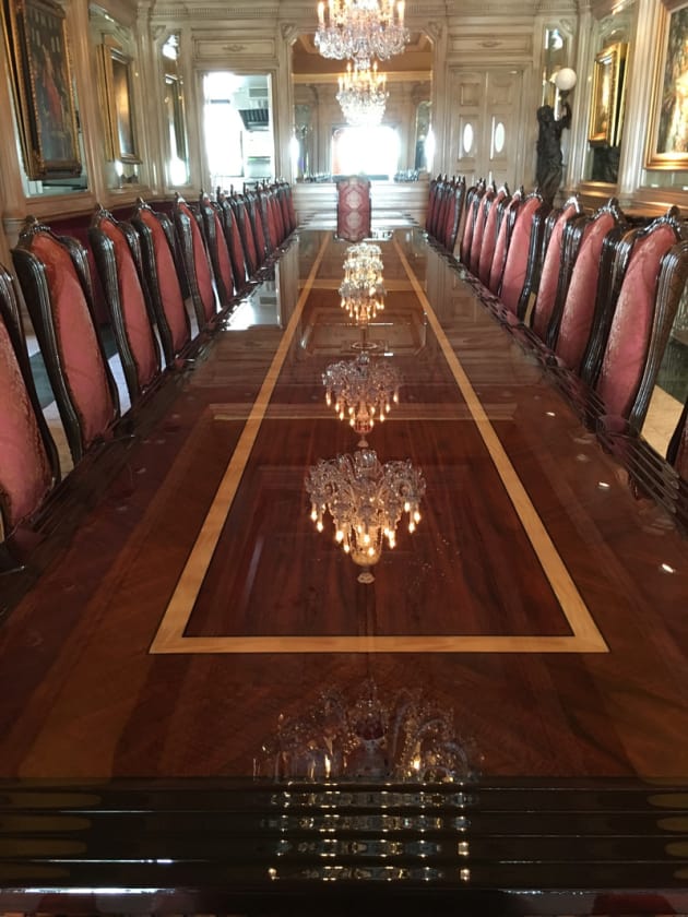 This 32 foot dining table with accompanying 26 chairs was a two month long commission. The table was made in eight foot sections from curly mahogany with sycamore banding .