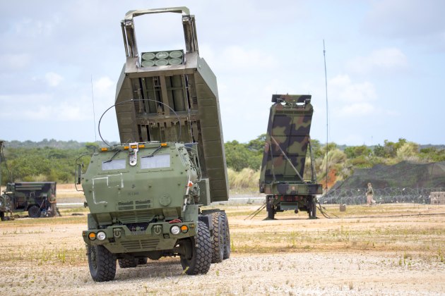 US Marines with 5th Battalion, 11th Marine Regiment set up an M142 High Mobility Artillery Rocket System in front of an AN/TPS-80 Ground/Air Task Oriented Radar with Marine Air Control Group (MACG) 18 at Andersen Air Force Base, Guam, June 13, 2022, in support of Valiant Shield 2022. (US Marine Corps photo by Cpl. Tyler Harmon)