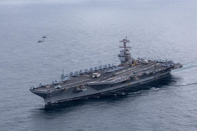 Two Carrier Air Wing 8 MH-60S Sea Hawks, attached to Helicopter Sea Combat Squadron 9, fly in formation over the world&rsquo;s largest aircraft carrier, USS Gerald R. Ford (CVN 78), during an aerial change of command. 
 
Credit: US Navy