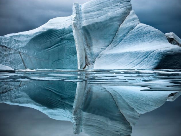 A quiet night on Ellesmere Island, in twenty-four hours of daylight. The high density of the cold water coupled by the high mass of its salt content makes for mirror-like reflections. Ellesmere Island, Canadian Arctic, 2008. &copy; Sebastian Copeland.