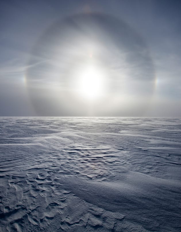 A sun dog on the Greenland ice sheet. Sun dogs are optical halos that are visible around the sun from the ice crystals in the air, 2010. &copy; Sebastian Copeland.