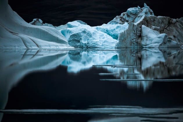 A quiet night on Ellesmere Island, in twenty-four hours of daylight. The high density of the cold water coupled by the high mass of its salt content makes for mirror-like reflections. Ellesmere Island, Canadian Arctic, 2008. &copy; Sebastian Copeland.