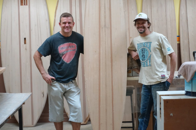 Greg Wallace (right) with a student in the surfboard building workspace of Bodhi Tree Surf.