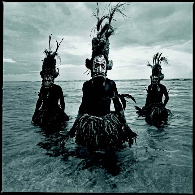 &copy; Chris Rainier. Malaggnan Shamans in masks, New Ireland, New
Guinea.