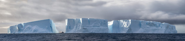 Personal work. An Epic
Sense of Scale. Polar
Pioneer (72 metres long),
sails into view in the
crevice of a monolithic
iceberg in Antarctica. &copy; Joshua Holko.