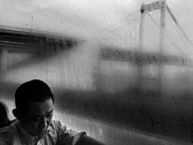 Public transportation in Tokyo. Commuter
sleeping on train while going to work. &copy; Andrea Francolini.