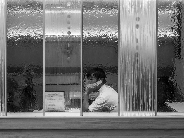 Man using mobile in cafe, Kyoto, Japan. &copy; Daniel Arnaldi.