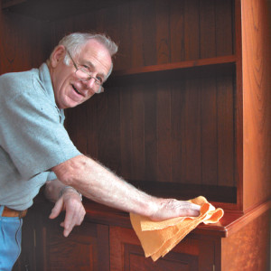 Master craftsman Frank Wiesner gives his highly figured cedar bookcase a final buff.