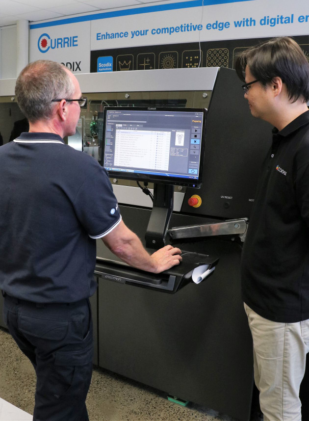 Currie Group's Steve Powne and Clarence Kwan from Scodix operate the Scodix