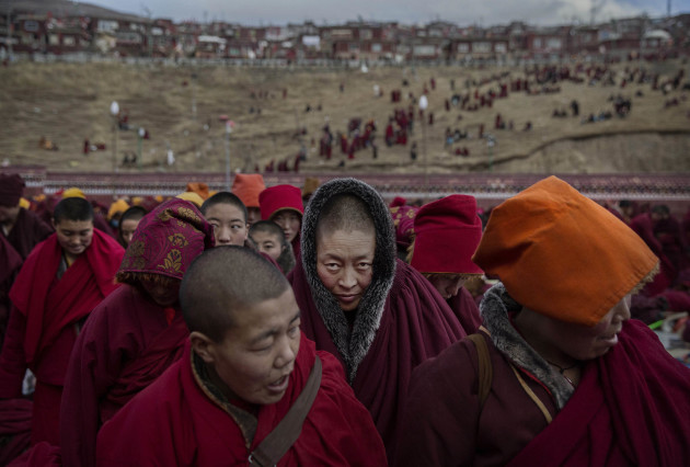 Daily Life, 2nd prize stories. &copy; Kevin Frayer, Canada, 2015, Getty Images. Tibetan Buddhist nuns stand following a chanting session in Sertar county,
Garze Tibetan Autonomous Prefecture, Sichuan province, China, 30 October 2015.