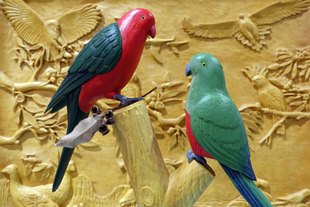 Kevin Gillis&rsquo;s King Parrots carved from jacaranda and jelutong stand before &lsquo;Australian Bird Collection&rsquo;, a wall-mounted relief carving in Huon pine made by three members of the Sydney Woodcarving Group for a raffle a few years ago.