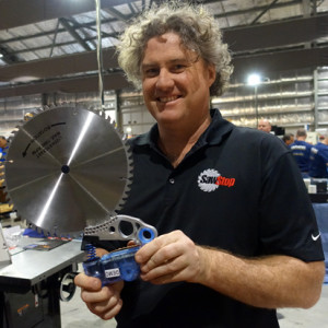 John Madden holds the SawStop safety brake mechanism.