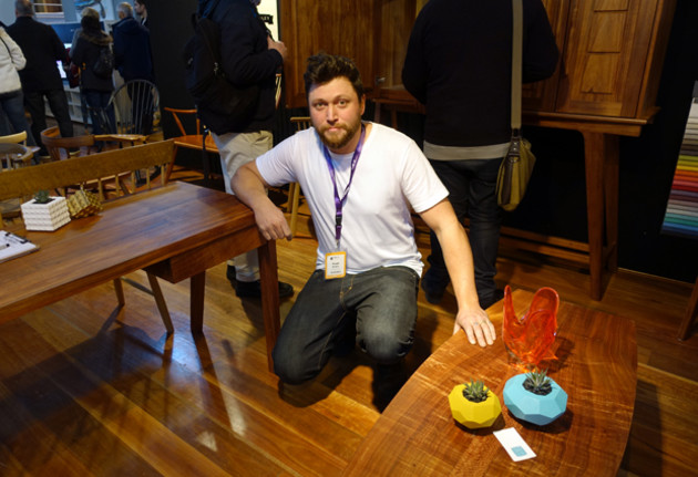 Hugh Makin, bespoke maker from Castlemaine, by his blackwood low table as he leans on his mid-century sideboard.
