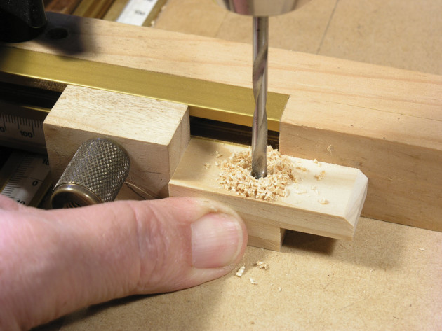 Drilling holes in the table buttons.