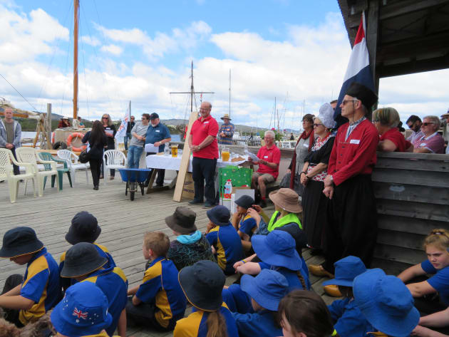 Steve Knight (standing in red) Chairman of the Australian Wooden Boat Festival gives a welcome address to visiting Dutch boatbuilders at Franklin&rsquo;s Wooden Boat Centre last December. Paul Cullen, General Manager of the MyState Australian Wooden Boat Festival stands to his right.