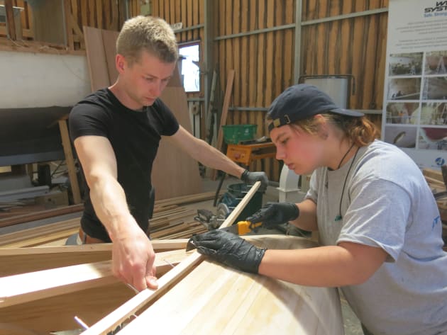 Miriam Taal cuts the planking into the bow while Jeroen van Ee steadies the timber.